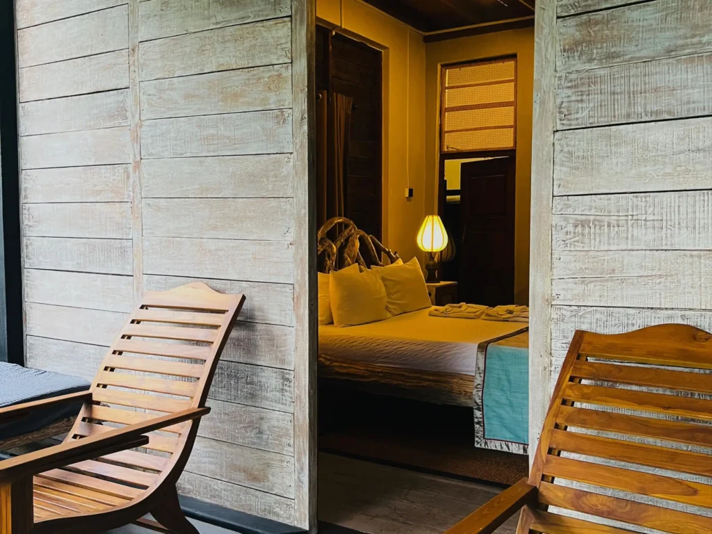 Cozy and elegant room at Sigiri Vananthara, featuring wooden accents and a serene ambiance, perfect for a relaxing stay at a resort in Sigiriya surrounded by nature.